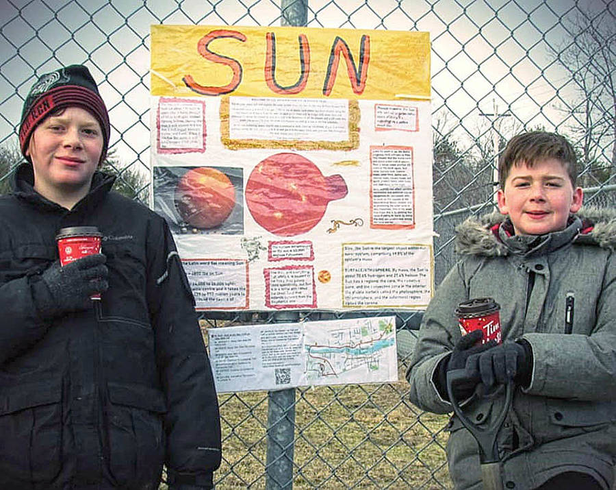 <p>CONTRIBUTED PHOTO</p><p>Logan and Liam McNeary stand next to a sign created for their Bridgewater Solar System Trail they&#8217;ve included in the Centennial Trail. One kilometre of trail equals one billion kilometres in space.</p>