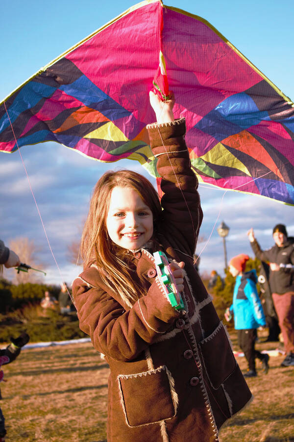 <p>PHOTOS BY ANNA KORINNA</p><p>Corissa MacDonald enjoys some evening kite flying, along with many others, young and old alike at the first Light Up Queens Winter Night Festival held March 16.</p>